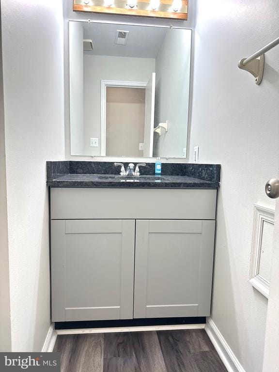 bathroom with vanity and hardwood / wood-style floors