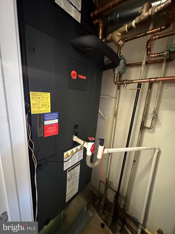 utility room featuring heating unit