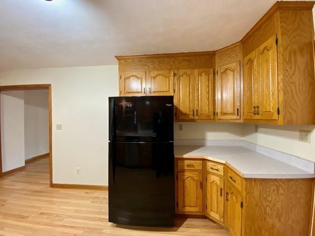 kitchen featuring black fridge and light wood-type flooring