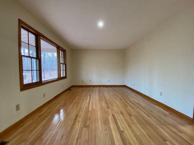 unfurnished room with light hardwood / wood-style floors