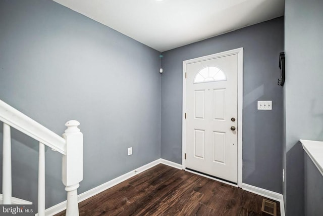 foyer entrance with stairs, dark wood-style flooring, visible vents, and baseboards