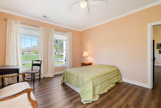 bedroom with visible vents, wood finished floors, baseboards, and ornamental molding