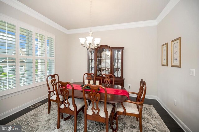 dining area featuring an inviting chandelier, hardwood / wood-style flooring, and crown molding