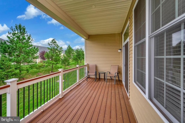 wooden deck with a lawn