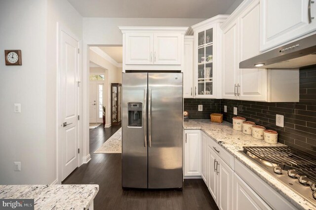 kitchen with stainless steel appliances, dark hardwood / wood-style floors, white cabinets, and light stone counters