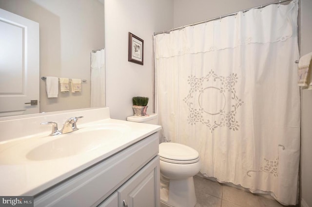 bathroom with vanity, curtained shower, tile patterned floors, and toilet