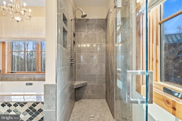 full bath with a chandelier and tiled shower