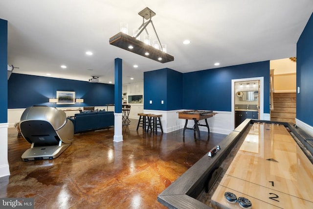 rec room with finished concrete flooring, baseboards, and recessed lighting