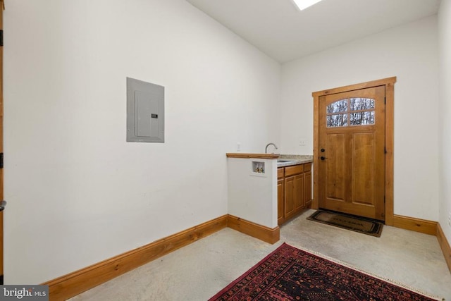 entrance foyer featuring electric panel and baseboards