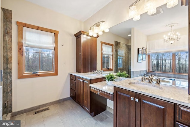 bathroom featuring two vanities, a sink, visible vents, a shower stall, and tile patterned floors