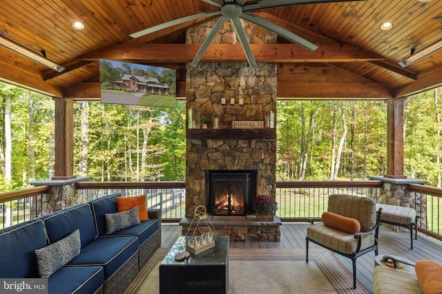 wooden deck with an outdoor living space with a fireplace