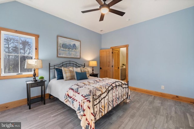 bedroom with ceiling fan, baseboards, and wood finished floors