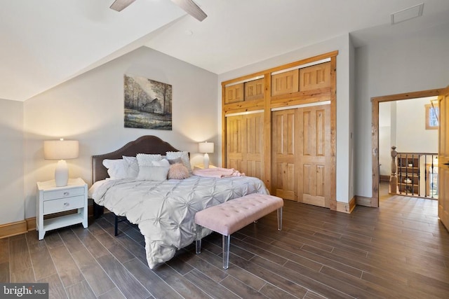 bedroom featuring lofted ceiling, visible vents, baseboards, and wood finish floors