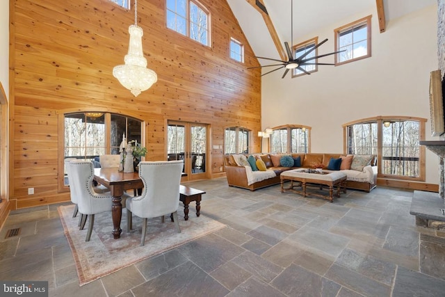 dining room with wooden walls and stone tile floors