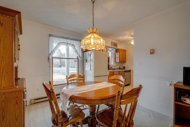 dining room with crown molding and baseboard heating