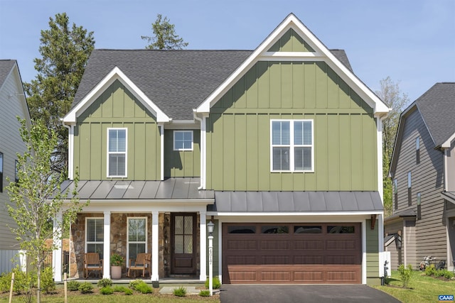 craftsman-style house featuring a garage, aphalt driveway, covered porch, roof with shingles, and board and batten siding