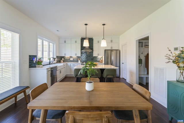dining area with baseboards, visible vents, and dark wood-type flooring