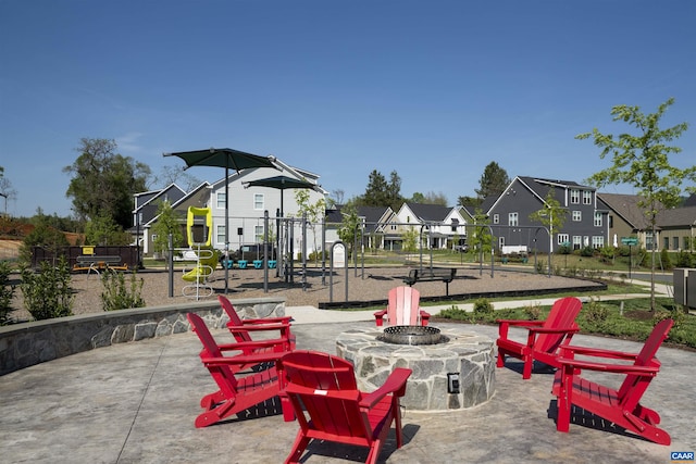 exterior space with a residential view, fence, a patio, and an outdoor fire pit