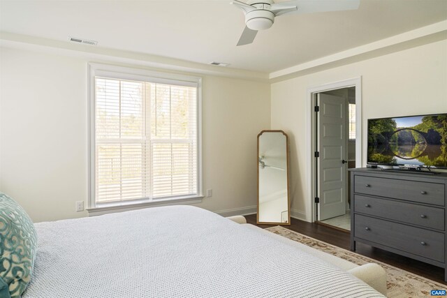 bedroom featuring visible vents, multiple windows, and wood finished floors