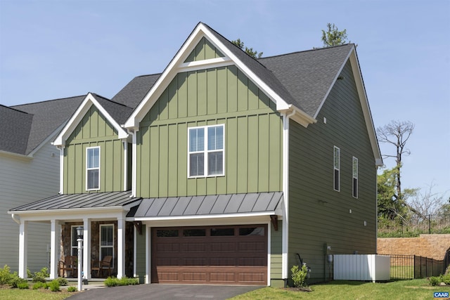 craftsman-style house featuring a standing seam roof, board and batten siding, and a shingled roof
