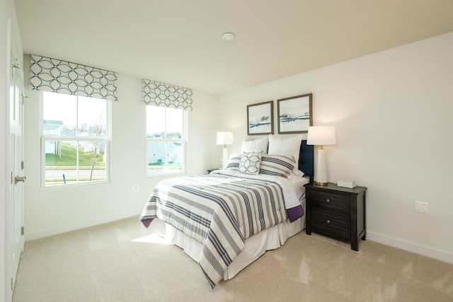 bedroom featuring light colored carpet