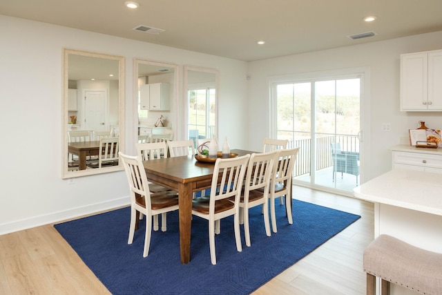 dining area featuring plenty of natural light and light hardwood / wood-style floors