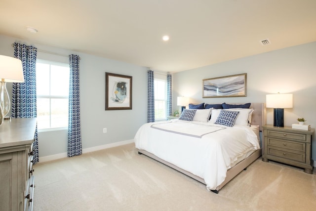 bedroom featuring light carpet