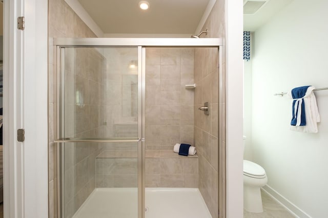 bathroom featuring walk in shower and toilet