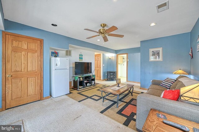 living room featuring recessed lighting, light colored carpet, visible vents, ceiling fan, and baseboards