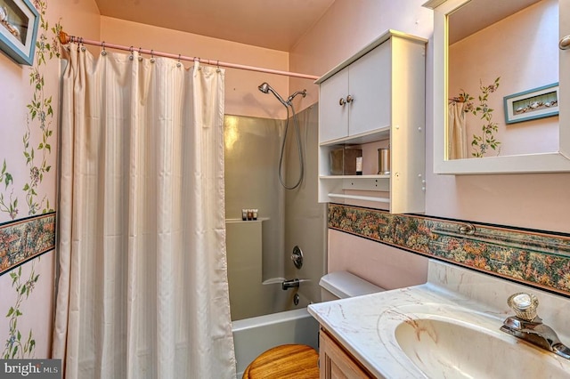 bathroom featuring shower / bath combo and vanity