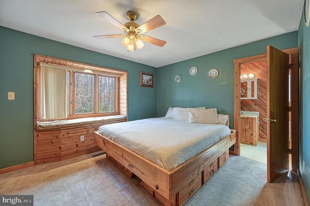 carpeted bedroom featuring ensuite bath, ceiling fan, and visible vents