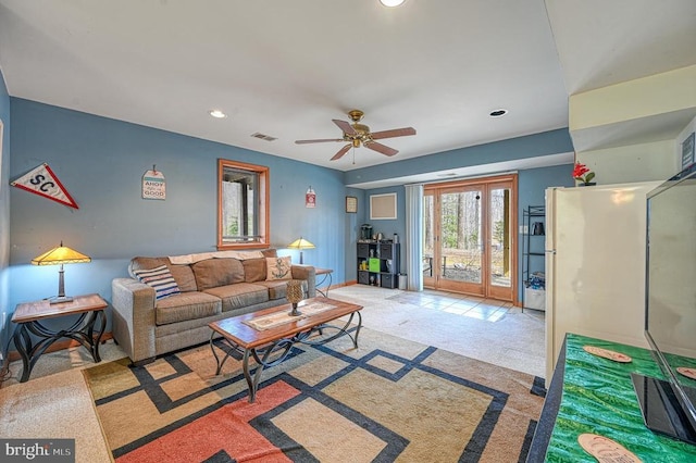 carpeted living room featuring visible vents, a ceiling fan, and recessed lighting