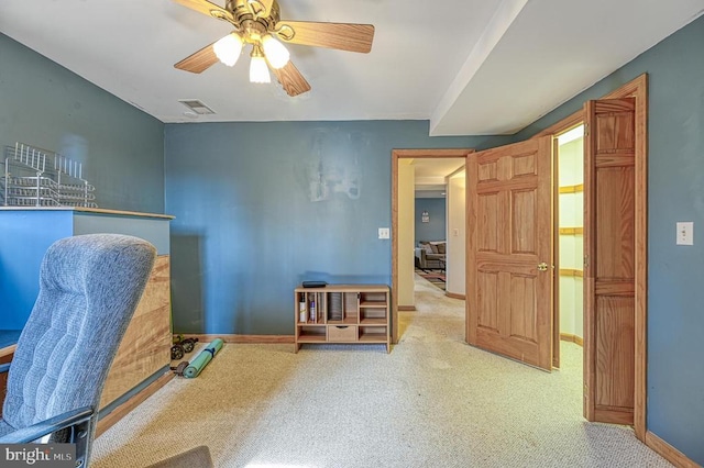 carpeted office space with ceiling fan, visible vents, and baseboards