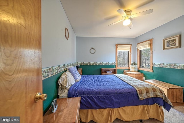 bedroom with a ceiling fan and carpet