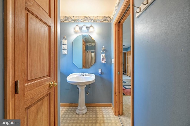 bathroom with baseboards and tile patterned floors