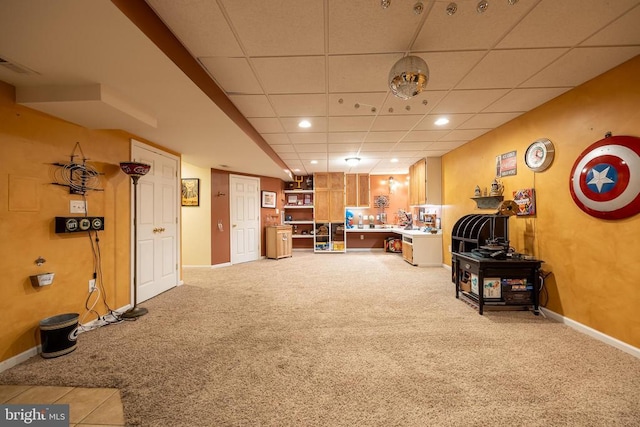 carpeted living room featuring a paneled ceiling