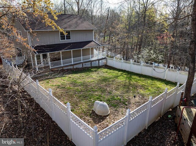 rear view of house featuring a yard