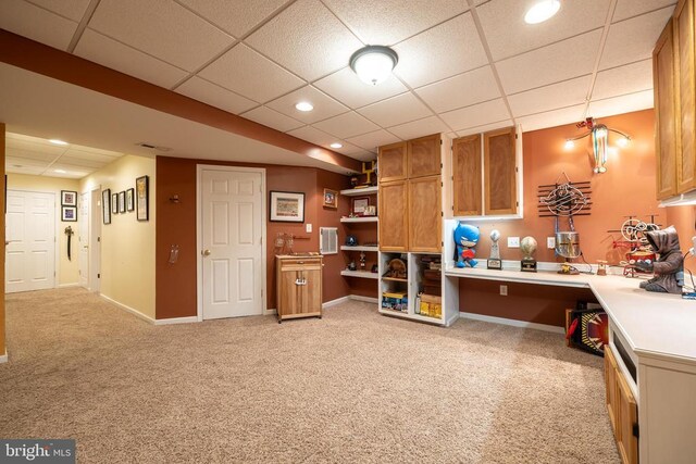 interior space with light carpet and a drop ceiling