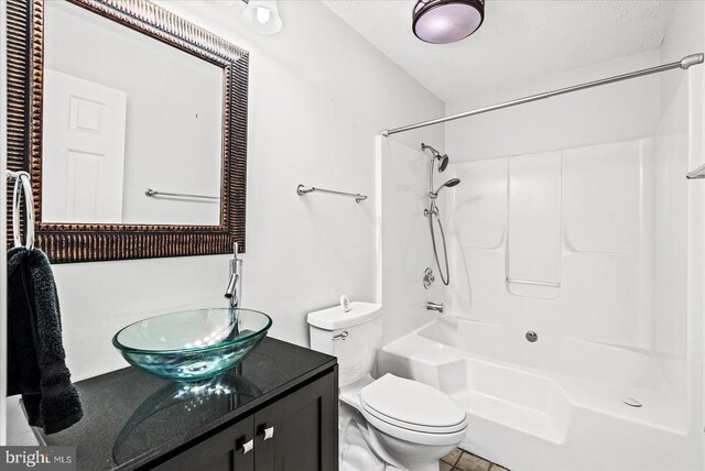 full bathroom with shower / tub combination, vanity, and toilet