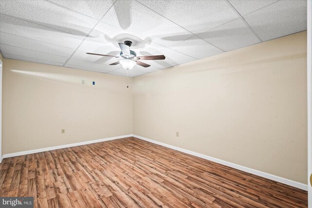 unfurnished room featuring hardwood / wood-style floors, a paneled ceiling, and ceiling fan