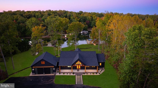 bird's eye view featuring a water view and a forest view