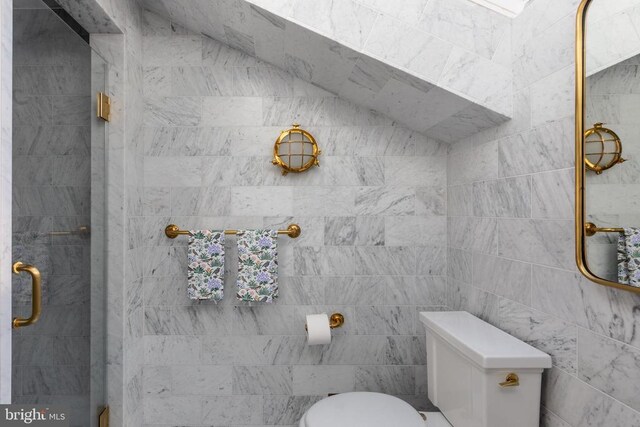 bathroom with toilet and a stall shower