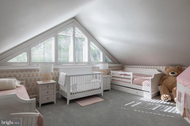 carpeted bedroom with lofted ceiling