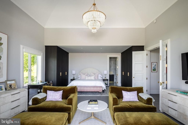 bedroom featuring high vaulted ceiling and a chandelier