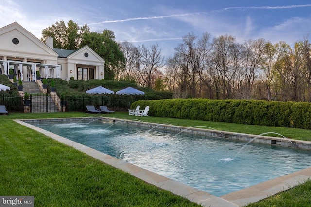 view of pool with fence, a lawn, and a fenced in pool