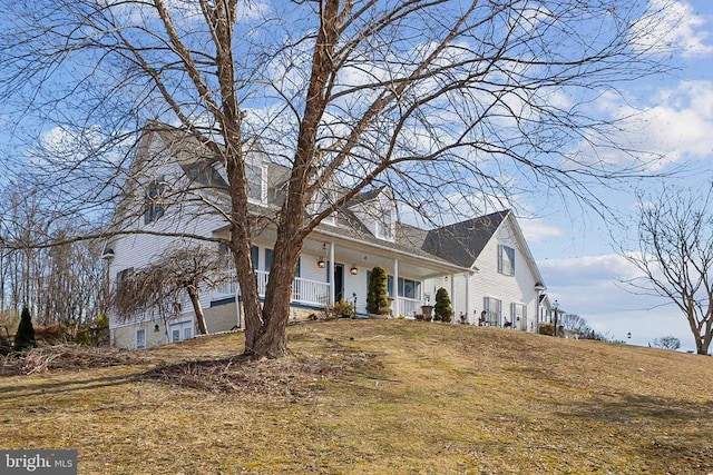 view of front of property with a porch and a front yard