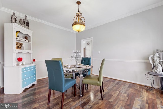 dining area featuring dark wood-style floors, baseboards, and crown molding