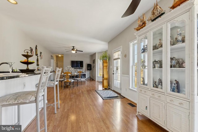 foyer with light wood-type flooring, visible vents, and a ceiling fan