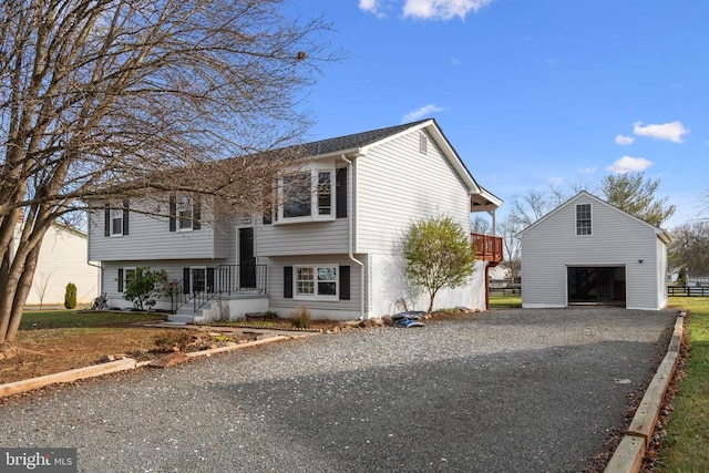 raised ranch featuring an outbuilding and a detached garage