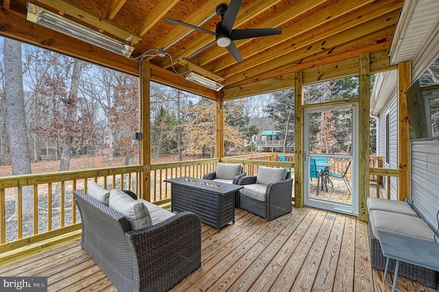 sunroom featuring a ceiling fan